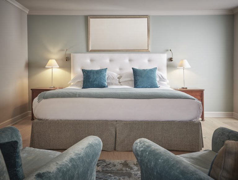 Classic bedroom at Whatley Manor with plush Harrison Spinks bed, elegant fabrics, and garden view