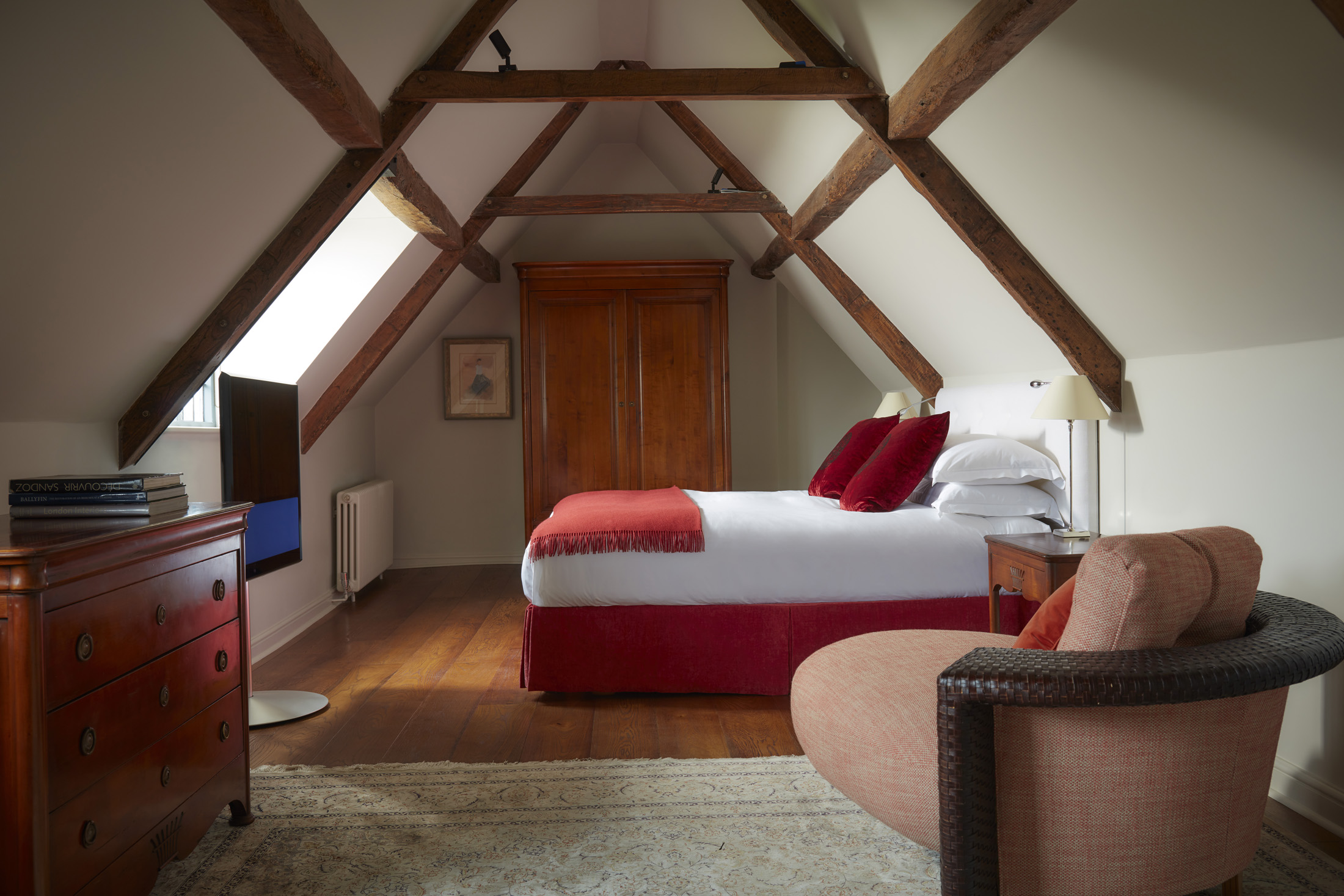 Grand Deluxe Suite bedroom with split-level architecture, super-king bed, and sweeping Wiltshire valley views
