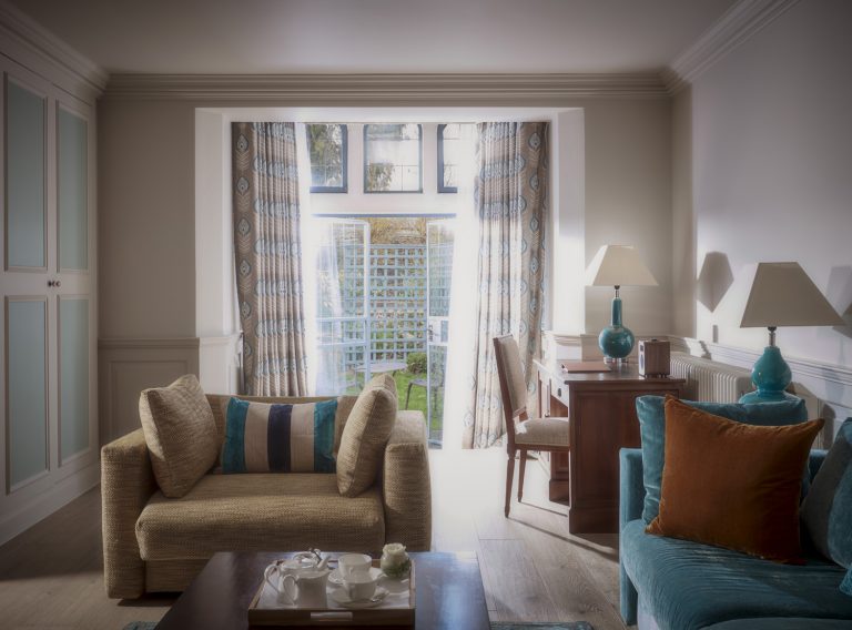 Junior Suite open plan lounge and bedroom with French doors overlooking the manicured Arts and Crafts gardens