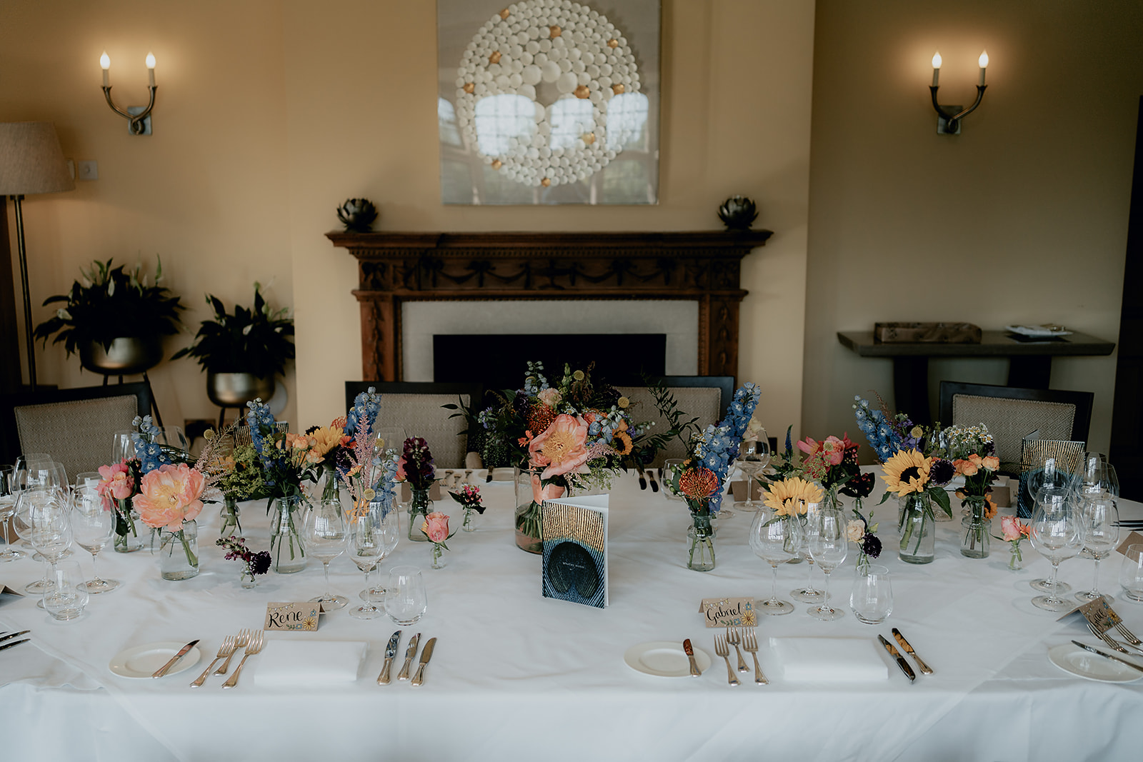 Intimate wedding reception set up with candlelit floral arrangements in Whatley Manor's private dining room